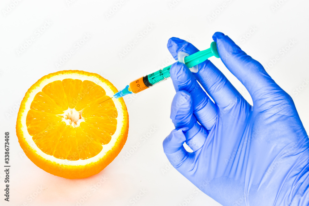 STOP GMO. type of fetus.A medical syringe with vitamin juice