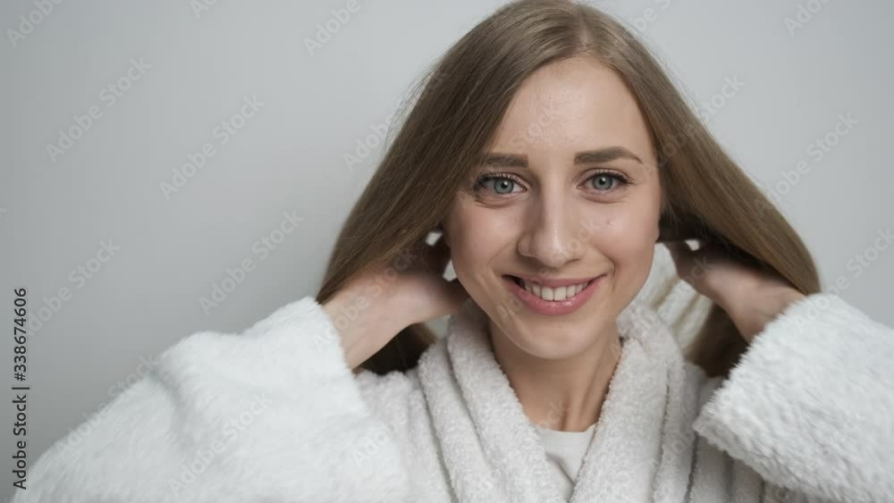 Beautiful girl in a bathrobe posing in front of the camera Beautiful girl in a bathrobe posing in front of the camera