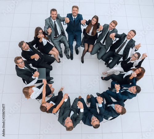 concept of team building .large successful business team sitting in a circle
