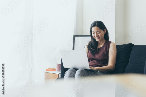 work from home.using computer.hand typing keyboard laptop online chatting search form internet while working sitting on sofa.concept for technology device contact communication business people