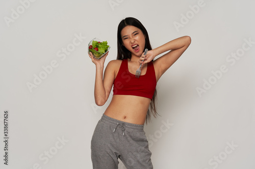 young woman holding a bowl of salad © SHOTPRIME STUDIO