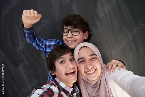 group of arab teens taking selfie photo on smart phone