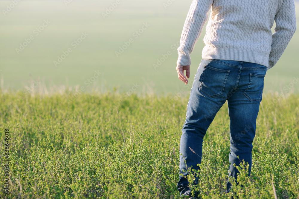 man on a hill among green meadows