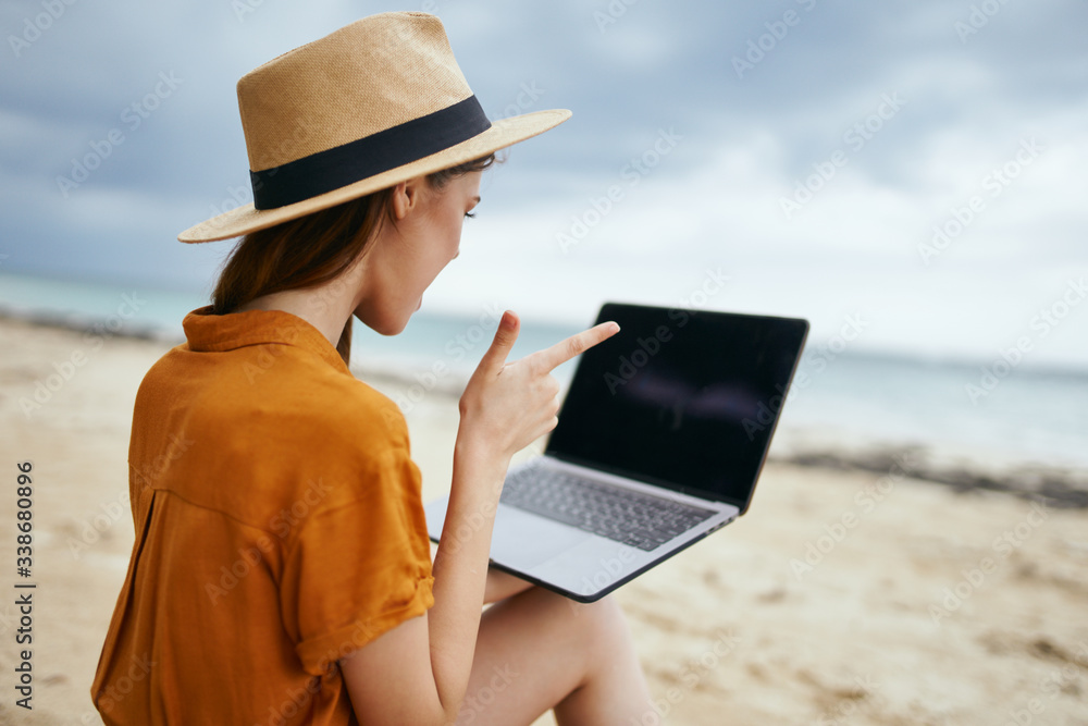 man with laptop on the beach