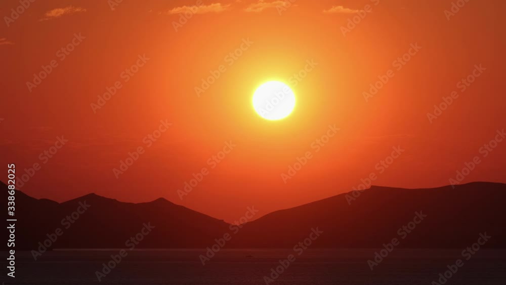 Morning. Dawn. Sunrise over the sea and mountains. Bright orange light. No people. Morning. Dawn. Sunrise over the sea and mountains. Bright orange light. No people.