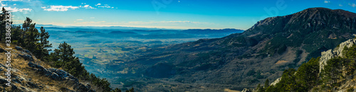 Panorama of the beautiful Vipava valley in the january sun looking from the Otlica plateau. Visible winter fog in the valley and the town of Lokavec at the bottom.