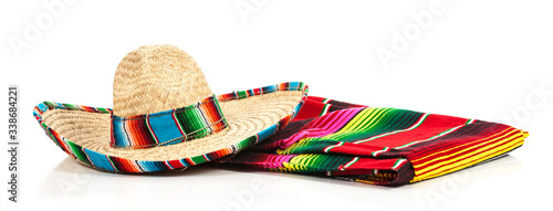 A woven Mexican sombrero or hat with a colorful serape blanket photo