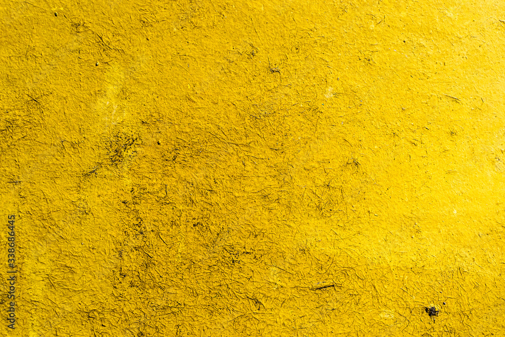 Scratched surface background in bright yellow