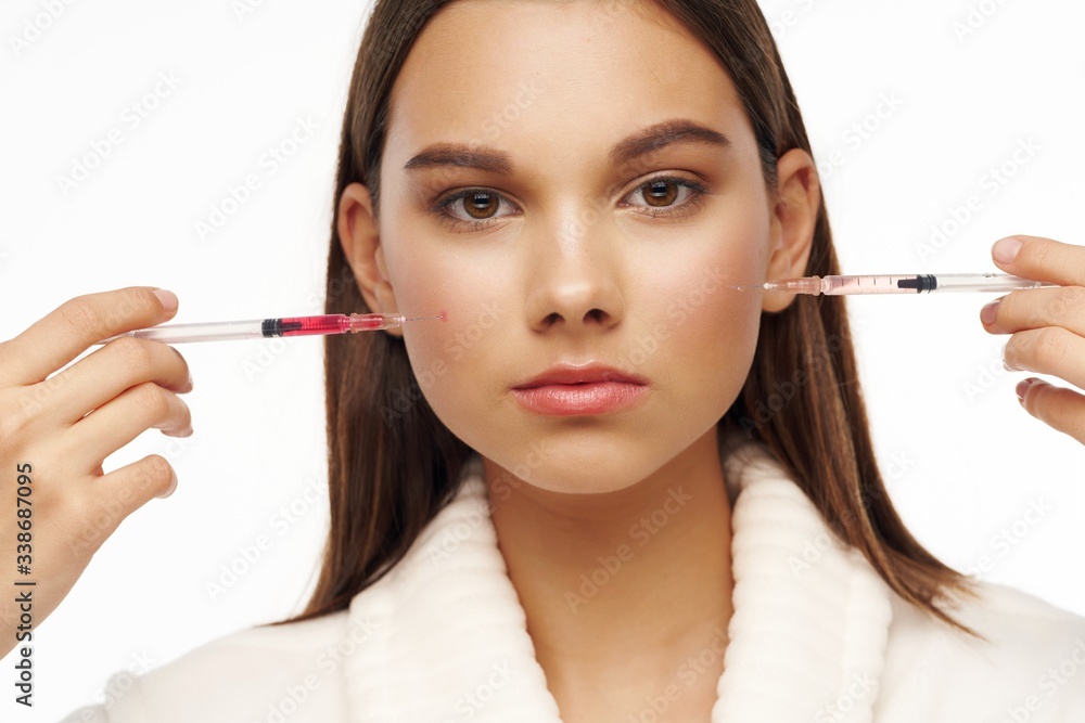 young woman applying mascara young woman applying mascara