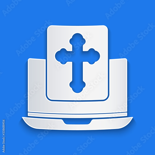 Paper cut Cross on the laptop screen icon isolated on blue background. Paper art style. Vector Illustration