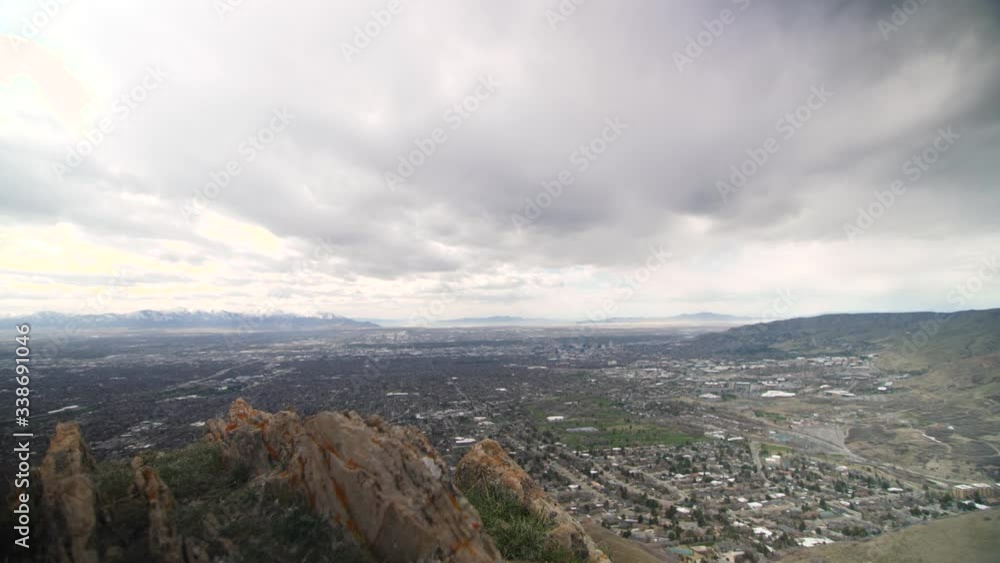 Overlook slider looking out over the Salt Lake City valley. Rock outcropping in foreground. Clouds moving overhead. Mountains and Great Salt Lake in distance. Overlook slider looking out over the Salt Lake City valley. Rock outcropping in foreground. Clouds moving overhead. Mountains and Great Salt Lake in distance.
