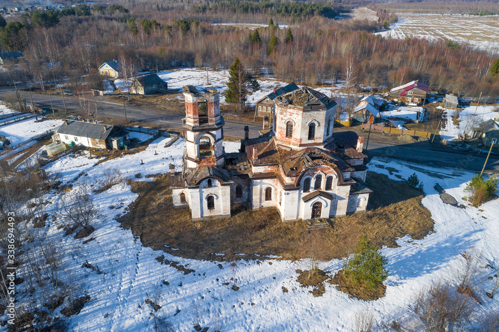 Old abandoned Rozhdestvenskaya church in the village of Verkhruchey on a April day (aerial photography). Karelia, Russia