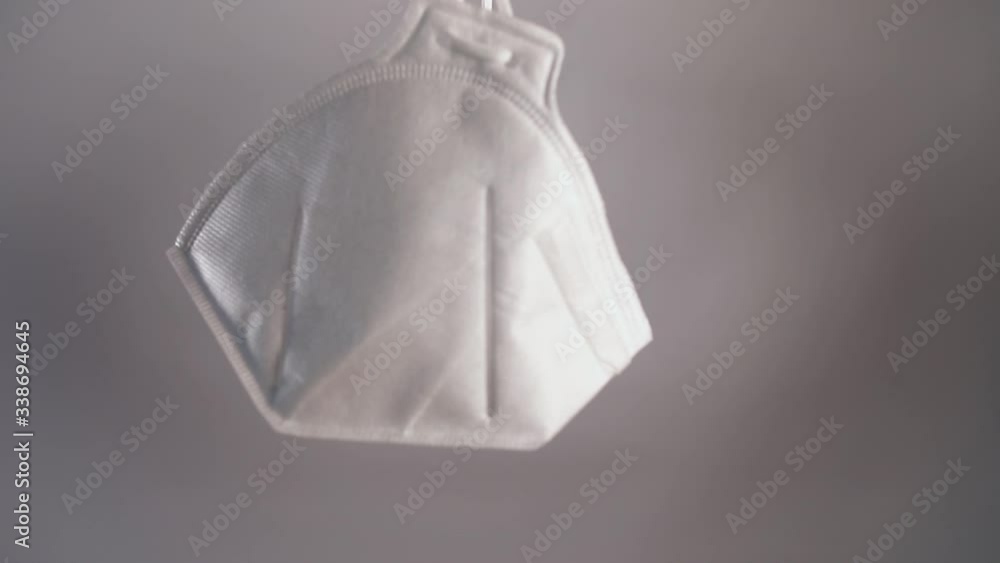 Protective respirator in male hands on a white background Protective respirator in male hands on a white background