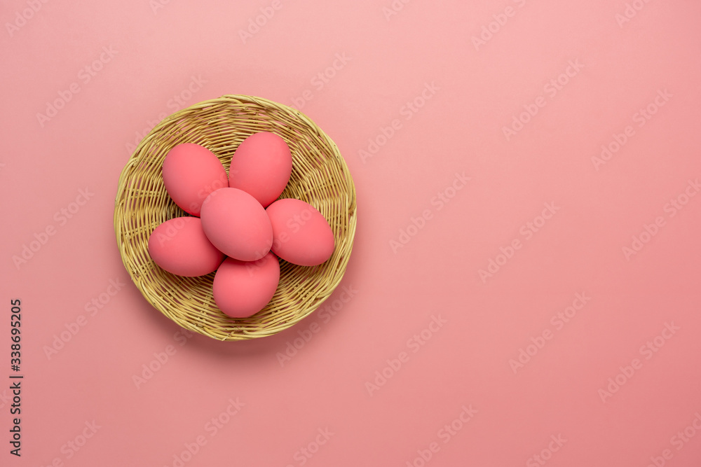 Top view aerial image of decoration & symbol Happy Easter holiday background concept.Flat lay accessory bunny eggs & floral on modern beautiful pink paper at home office desk.Free space for design.