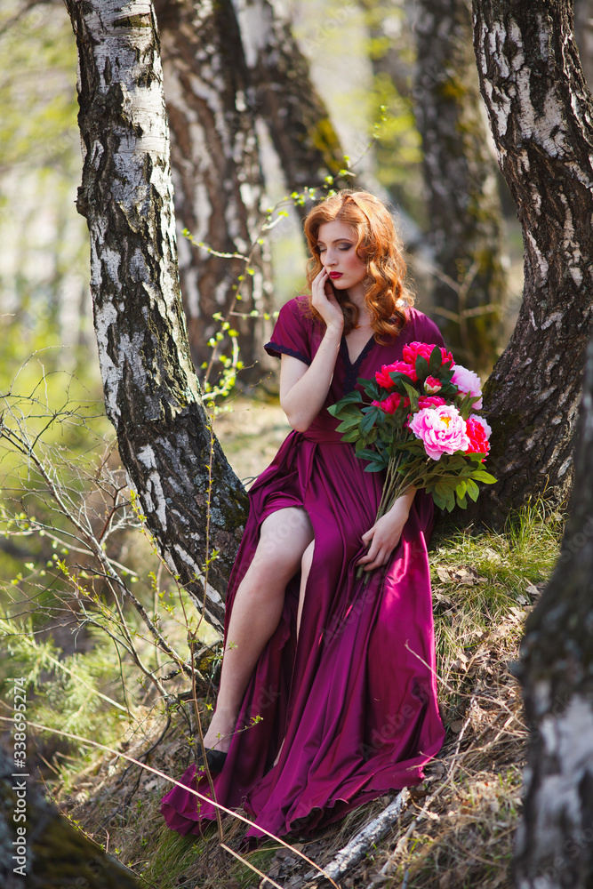 red-haired girl in a burgundy dress walks in the forest red-haired girl in a burgundy dress walks in the forest