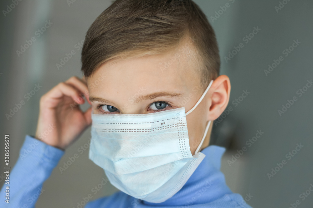The child puts on a protective mask The child puts on a protective mask