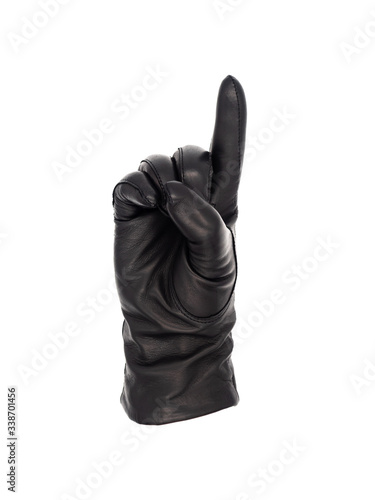 Isolated woman's hand wearing a black leather glove palm up, in a pointing or number 1 gesture with the thumb crossing the palm and depressing the other fingers