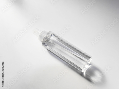 Clear plastic spray bottle on white background