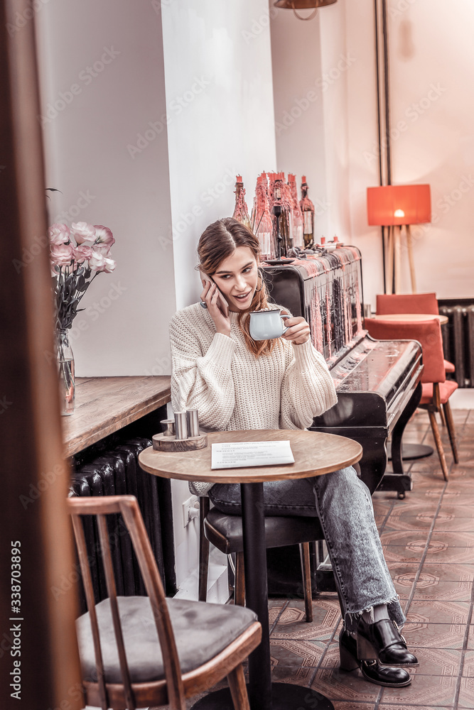 Gorgeous young woman sitting at cafe drinking coffee Gorgeous young woman sitting at cafe drinking coffee