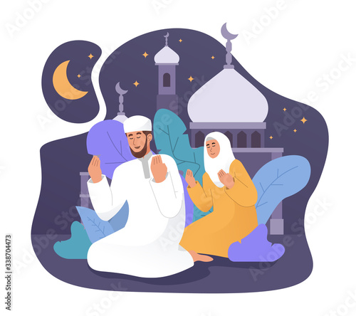 Muslim man and his wife praying together at night