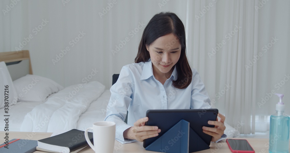 Young woman work from home with tablet in bedroom Young woman work from home with tablet in bedroom