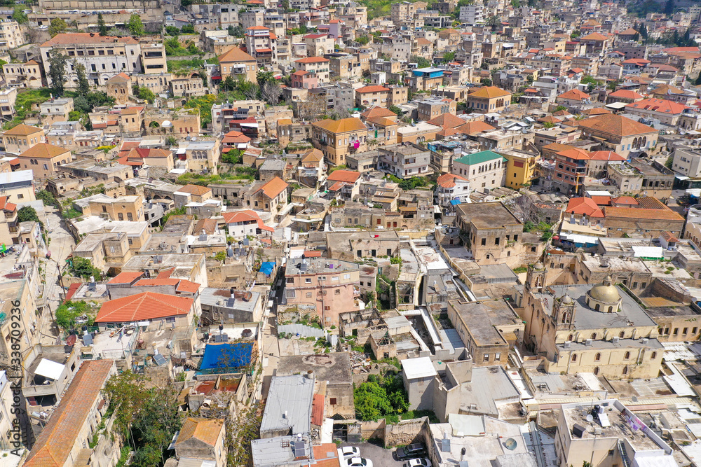 Aerial image of the over the old city houses of Nazareth during Corona Virus lockdown, with no people of traffic in the streets.
