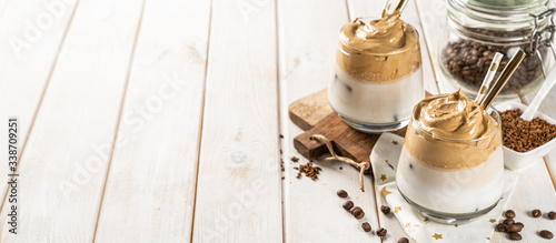 Coffee trend - dalgona coffee, whipped instant coffee on rustic background, copy space photo