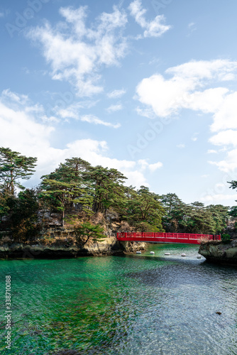 Red bridge connecting two islands in Matshushima Bay near Sendai in Tohoku, Japan on a sunny winter day.