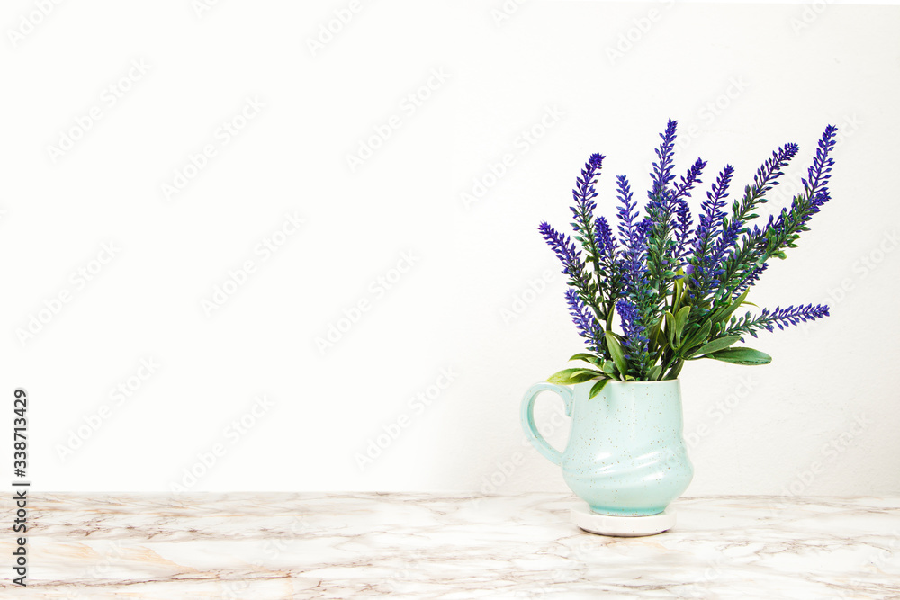Lavender flowers in a mug on a marble table Lavender flowers in a mug on a marble table