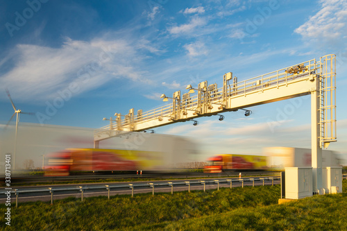 Bild auf Leinwand truck traffic under the highway gantry