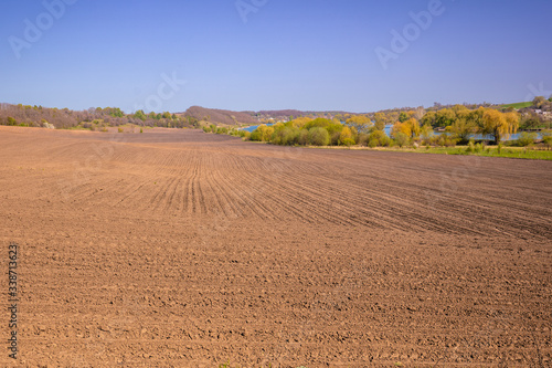 View of the arable field on a sunny day. Rural landscape