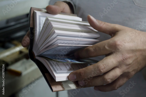 Tehran/ Iran - 10 11 2014: A close-up of a little book in Persian held in hands. Coran, religion