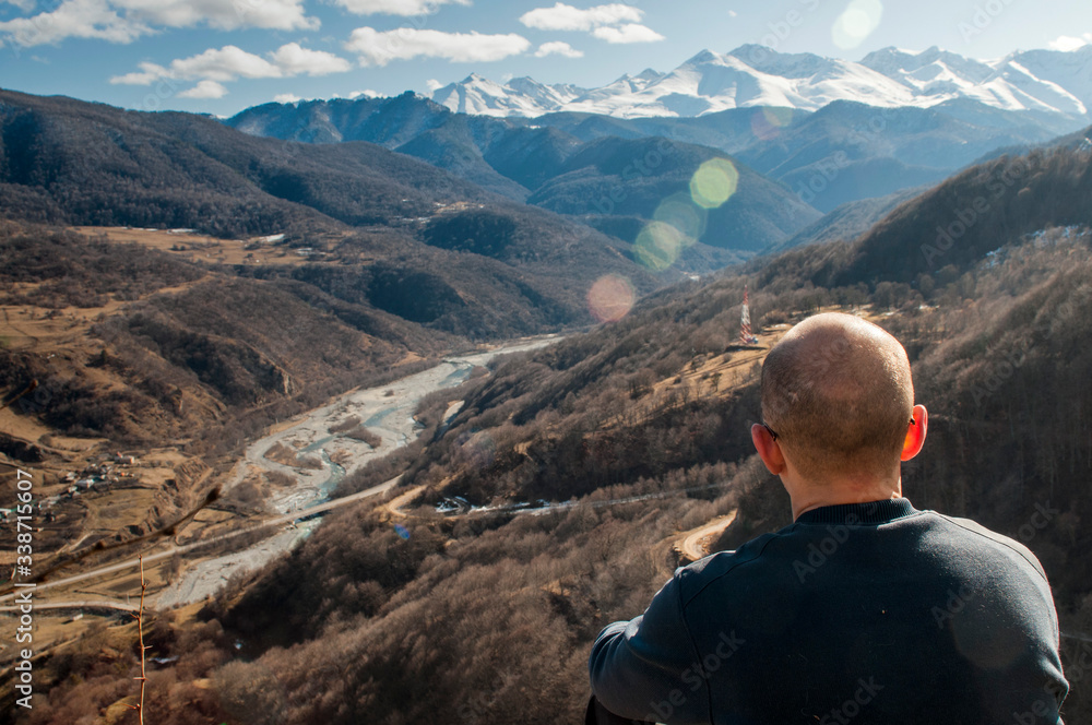 First person perspective shot from a hiker sitting at the edge of a cliff.