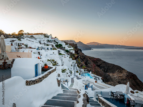A morning shot of the Greek island of Santorini showing steps leading down to apartments. 