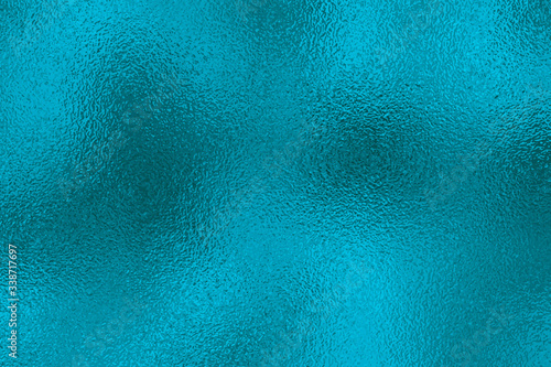 Metallic effect. Blue texture shine foil. Turquoise abstract background with glitterer metal effect. Green surface. Backdrop glitter mint metal plate. Metallic texture foil for design prints