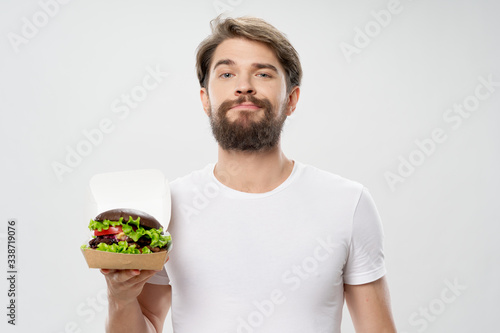 young man eating fresh salad