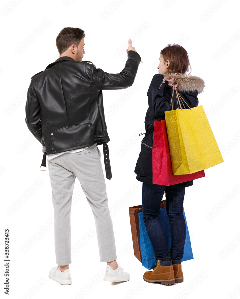 back view of couple with shopping bags in winter jacket. back view of couple with shopping bags in winter jacket.