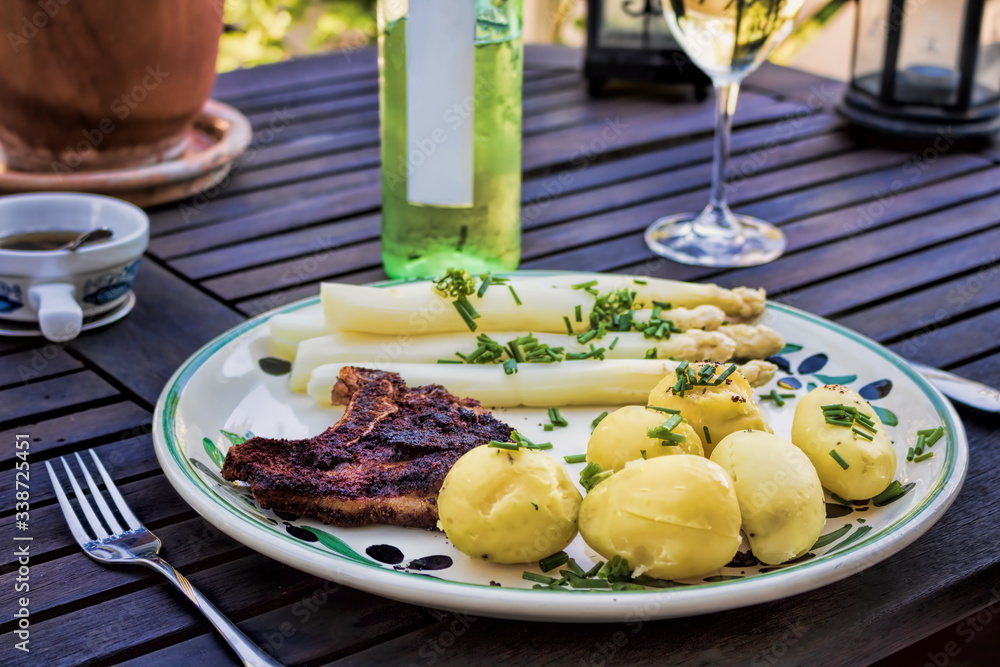 erkner, deutschland - kotelett mit spargel und weißwein erkner, deutschland - kotelett mit spargel und weißwein