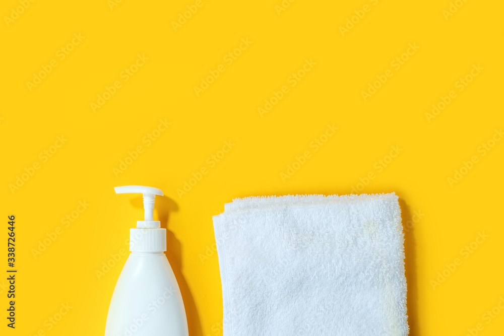 Sanitizer antiseptic gel liquid soap and white towel on yellow background. People are stocking up essentials for home quarantine. Consumer buying panic about coronavirus covid-19 concept, hygiene good Sanitizer antiseptic gel liquid soap and white towel on yellow background. People are stocking up essentials for home quarantine. Consumer buying panic about coronavirus covid-19 concept, hygiene good
