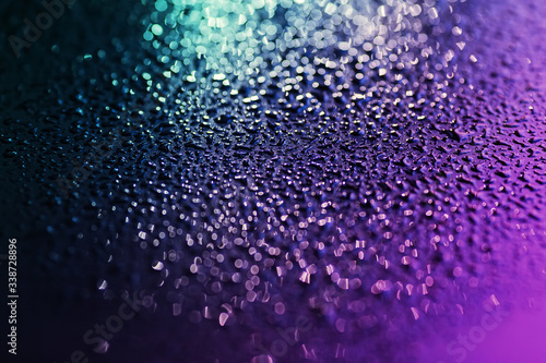 Close up of water drops on the black metal.