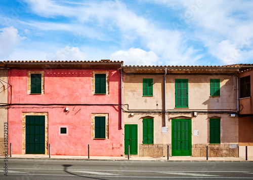 Old buildings with wooden shutters by a street in Alcudia, Mallorca. © MaciejBledowski