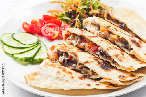 Turkish gozleme tortilla. Tortilla with vegetables on a white plate.