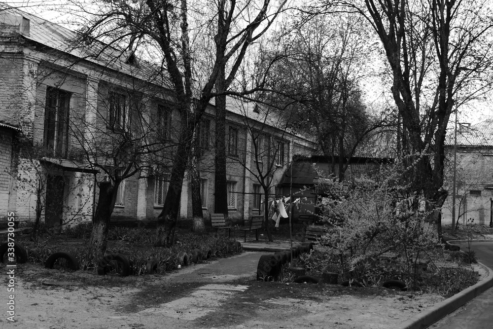 old building with the trees and linen that is dried outside old building with the trees and linen that is dried outside