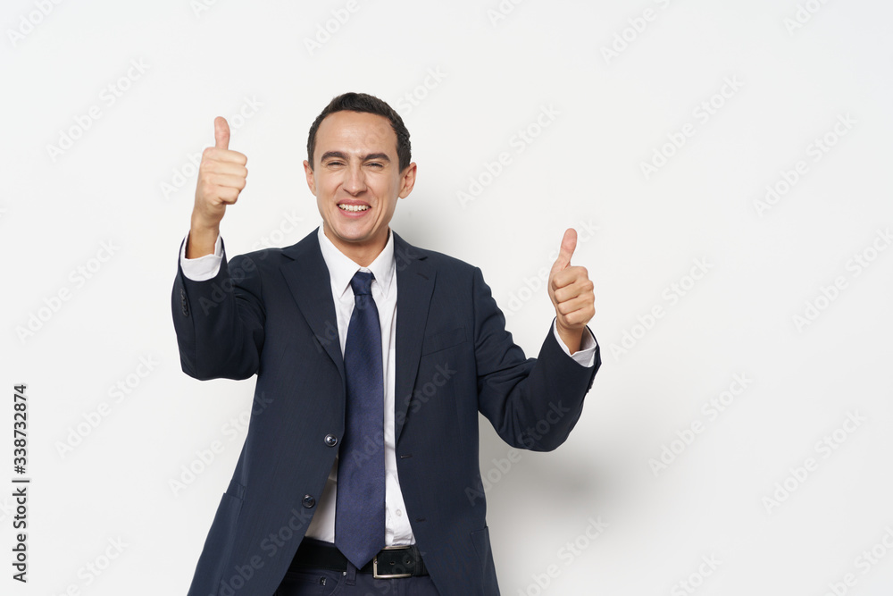 young businessman showing thumbs up young businessman showing thumbs up