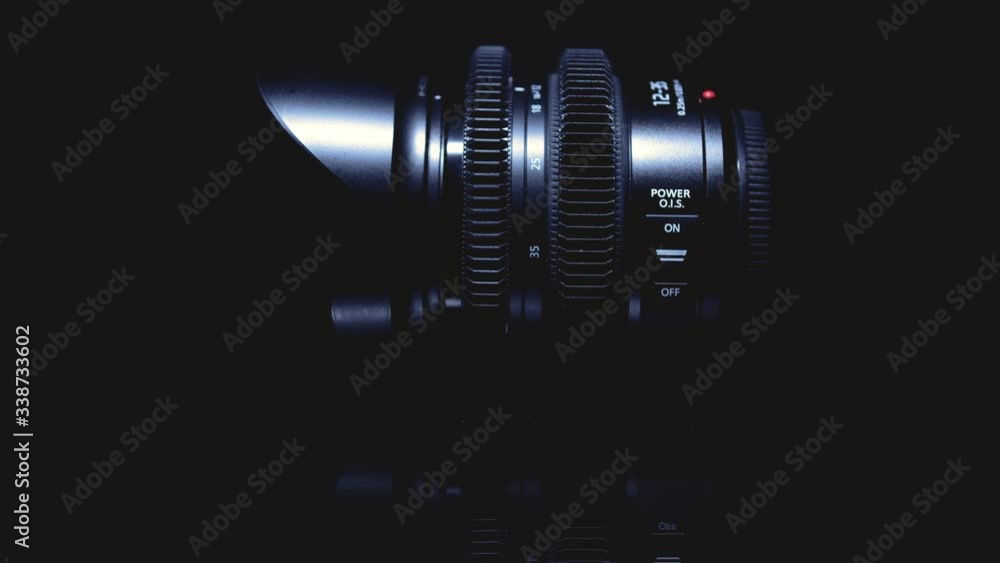 Film lens is artistically lit on a black background. Advanced optical technology. Film lens is artistically lit on a black background. Advanced optical technology.