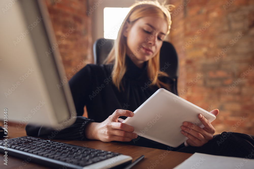 Analyzing, reading. Caucasian young woman in business attire working in office. Young businesswoman, manager doing tasks with smartphone, laptop, tablet has online conference. Finance, job. Analyzing, reading. Caucasian young woman in business attire working in office. Young businesswoman, manager doing tasks with smartphone, laptop, tablet has online conference. Finance, job.