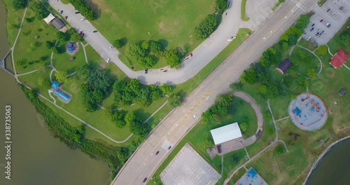 Aerial view over a lakeside neighborhood park. Bird's-eye view of the community park next to a lake photo