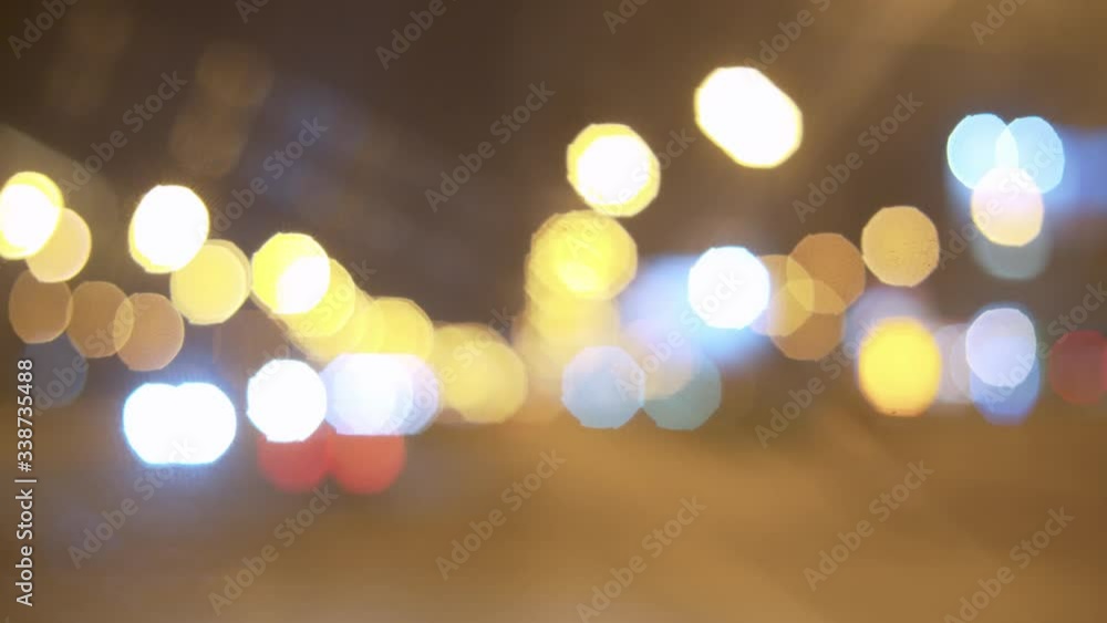 Blurry city traffic lights in the night. Abstract background. Colorful bokeh car lights in traffic on highway. Blurry city traffic lights in the night. Abstract background. Colorful bokeh car lights in traffic on highway.
