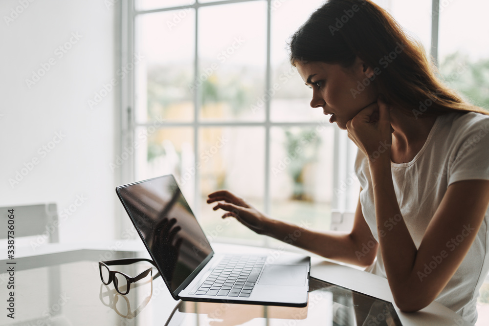 Woman at home in front of laptop communicating Woman at home in front of laptop communicating