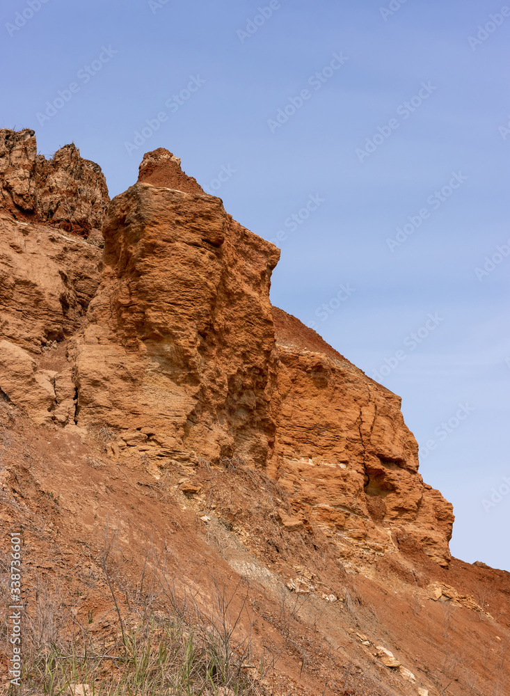 Natural landslide processes on the Black Sea coast. Shell rock cliff. Geological structure of the soil